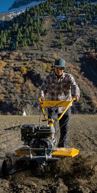 Tractor cultivating wet farm field